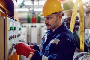 A trained Generator Technician working at the control panel. 